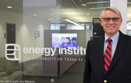 Dave Tuttle stands outside the entrance to the Energy Institute office