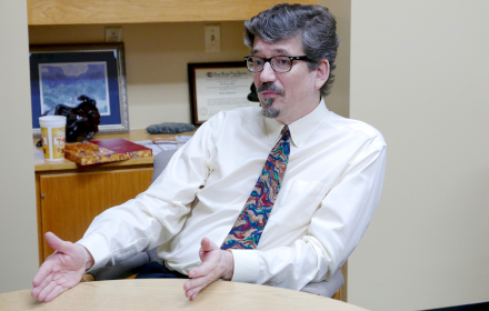 Jon Olson being interviewed at his desk