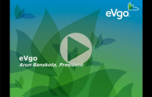 Title slide from Arun Banskota's presentation at UT Energy Symposium, with blue and green abstract images and the eVgo logo