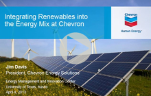 Title slide from Jim Davis' presentation at UT Energy Symposium, showing solar panels in a field of wildflowers with wind turbines in the distance