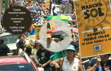 a slide from Elivan Martinez's persentation at UT Energy Symposium, showing people marching with signs, with an overlay that reads "faster transformation + community based + rooftop solar systems"