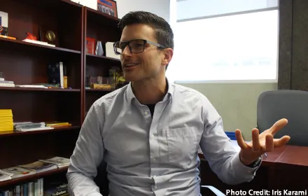 Josh Rhodes speaking, at a desk