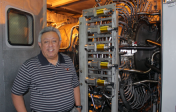 Juan Ontiveros stands in front of power plant equipment