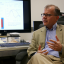 Professor Erich Schneider being interviewed at his desk