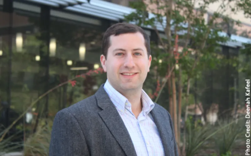 Ben Leibowicz standing outside on the UT Austin campus