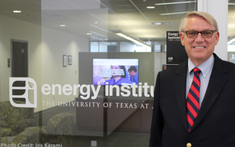 Dave Tuttle stands outside the entrance to the Energy Institute office