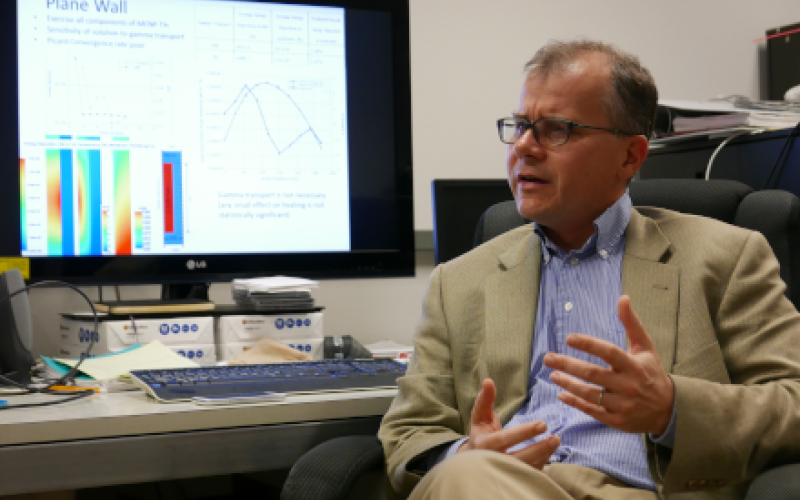 Professor Erich Schneider being interviewed at his desk