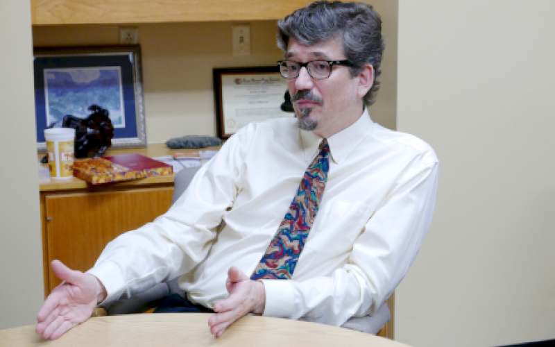 Jon Olson being interviewed at his desk