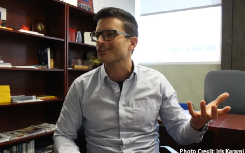 Josh Rhodes speaking, at a desk